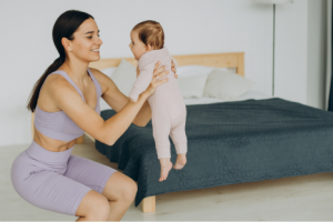 mother-with-her-baby-daughter-practice-yoga-home 1